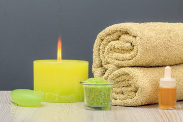 Fototapeta na wymiar Spa composition with towel, oil, sea salt and soap.