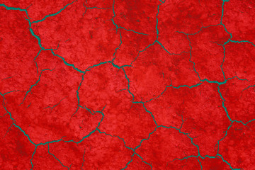 Cracked earth, cracked red soil. Abstract texture of grungy dry cracking parched earth. Global worming effect.