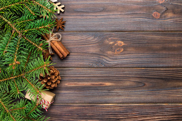 Christmas background with fir tree and gift box on wooden table. Top view with copy space for your design