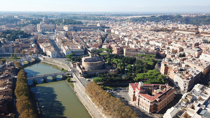Fototapeta premium Aerial drone view of iconic Castel Sant'Angelo (castle of Holy Angel) and Ponte or bridge Sant'Angelo with statues in river of Tiber next to famous Vatican, Rome, Italy