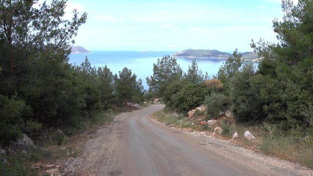 4K Whirling road downhill with stunning sea view