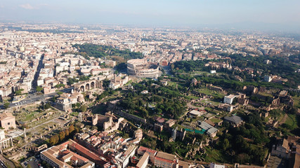 Aerial drone view of iconic and beautiful ancient Arena of Colosseum, also known as the Flavian amphitheatre in the heart of Roman Forum, rome, Italy
