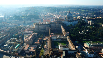 Aerial drone view of Saint Peter's square in front of world's largest church - Papal Basilica of St. Peter's, Vatican - an elliptical esplanade created in the mid seventeenth century, Rome, Italy