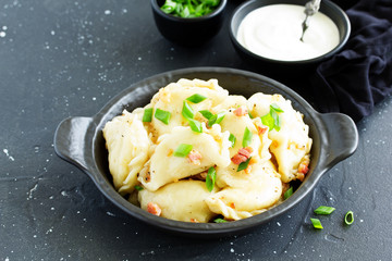 dumplings with potatoes in onion and bacon sauce. Varenyky, vareniki, pierogi, pyrohy.