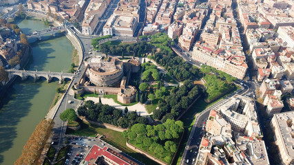 Aerial drone view of iconic Castel Sant' Angelo (castle of Holy Angel) and Ponte or bridge Sant'Angelo with statues in river of Tiber next to famous Vatican, Rome, Italy