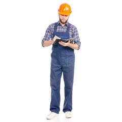 Young man builder industry worker hardhat with a notebook and pen in hand on white background isolation