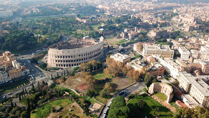 Obraz premium Aerial drone view of iconic ancient Arena of Colosseum, also known as the Flavian amphitheatre in the heart of Rome, Italy