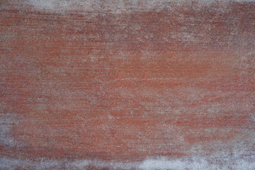 Texture of metal with touches of white paint. Textural background of painted metal with white strokes of paint. Design on a red-brown metallic background.