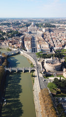 Aerial drone view of iconic Castel Sant' Angelo (castle of Holy Angel) and Ponte or bridge Sant'Angelo with statues in river of Tiber next to famous Vatican, Rome, Italy
