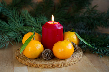 Christmas card with fresh mandarins on wooden background.