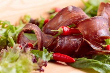 Dry beef jerky with herbs and red peppers.