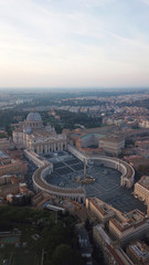 Aerial drone view of Saint Peter's square in front of world's largest church - Papal Basilica of St. Peter's, Vatican - an elliptical esplanade created in the mid seventeenth century, Rome, Italy