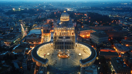 Obraz premium Aerial drone night view of Saint Peter's square in front of world's largest church - Papal Basilica of St. Peter's, Vatican -an elliptical esplanade created in the mid seventeenth century, Rome, Italy