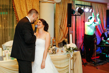 Beautiful wedding couple speaking on microphone