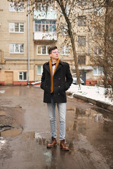 Young man with a urban look in city. hipster man in the city winter