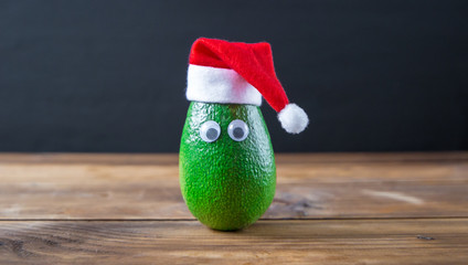 Christmas avocado. avocado in christmas hat. holidays concept