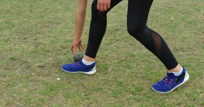 Female athlete holding shot put ball at sport venue 4k