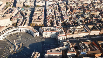 Fototapeta premium Aerial drone view of Saint Peter's square in front of world's largest church - Papal Basilica of St. Peter's, Vatican - an elliptical esplanade created in the mid seventeenth century, Rome, Italy