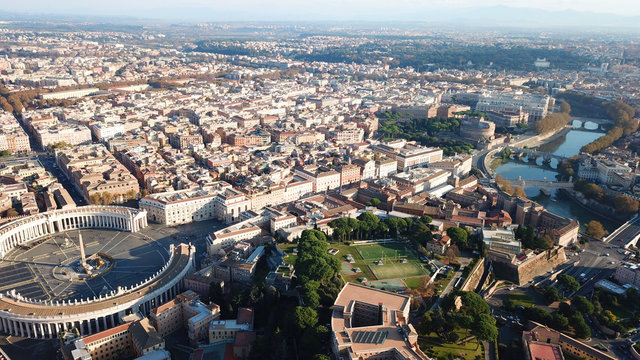 Aerial drone bird's eye view of iconic architecture in city of Rome next to river Tiber, Italy