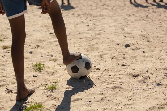 Boy playing football in the ground
