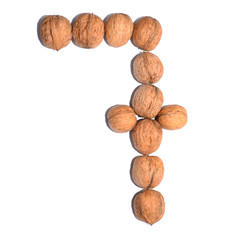 Number seven. Figure composed of nuts on a white isolated background.