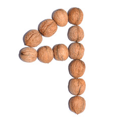 Number four. Figure composed of nuts on a white isolated background.