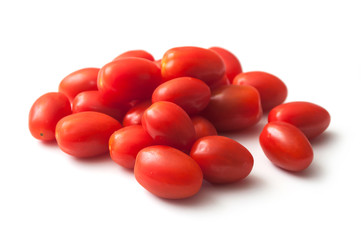 closeup of mini organic tomatoes roma on white background - obrazy, fototapety, plakaty