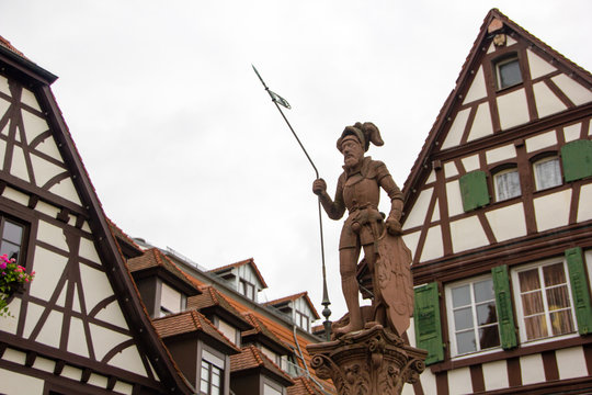 Timbered houses with warrior sculpture at the market place in Bretten, Germany