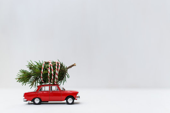 Red toy car with a christmas tree on the roof
