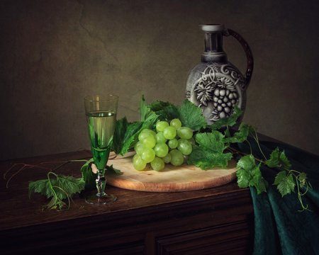 Still life with white wine and grapes