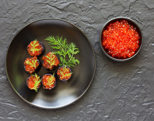 Pancakes with cuttlefish ink with red caviar. Russian kitchen.