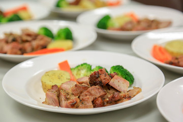 Steak pork sliced cube with vegetables such as tomatoes, carrot, broccoli and pineapple.
