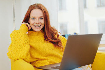 Excited enthusiastic young woman looking at camera