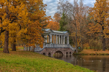 Marble bridge in autumn foliage in Catherine park (Pushkin), St. Petersburg, Russia