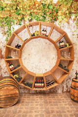 Old wine barrels, grapes, casks and bottles in wine-cellar