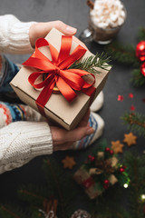 Person holding Christmas present gift box. Kid child girl holding box of presents