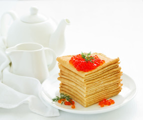 A pile of pancakes in Russian style with red caviar. .
