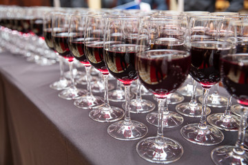 Rows of red wine glasses for party and wedding.