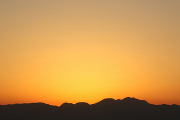 Fototapeta premium View from Enoshima island to mountain silhouettes with dramatic sunset, Fujisawa, Kanagawa prefecture, Japan