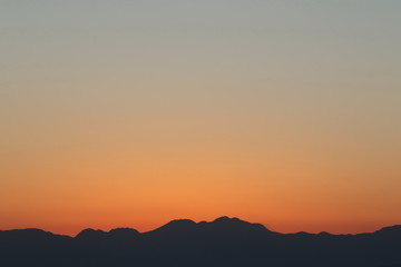 View from Enoshima island to mountain silhouettes with dramatic sunset, Fujisawa, Kanagawa prefecture, Japan
