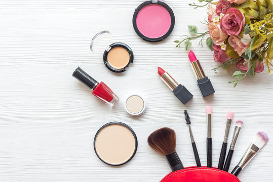 Makeup cosmetics tools background and beauty cosmetics, products and facial cosmetics package lipstick, eyeshadow with rose on the white background, vintage tone. Lifestyle Concept