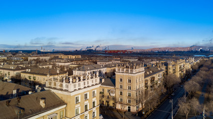 Fototapeta na wymiar Aerial; drone panoramic view of Magnitogorsk cityscape with old buildings in empire style with decoration elements; beautiful development, architectural complex and parks; industrial background