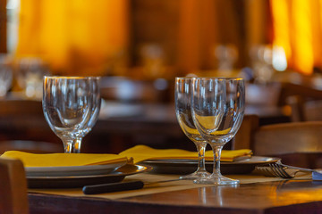 Served table at restaurant terrace on the blurred bright background