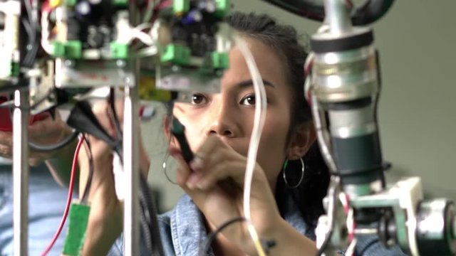 Engineer female collaborating development robot in modern laboratory. concept of hardware technology, robotic engineering, artificial intelligence and automation control. 4K Resolution.