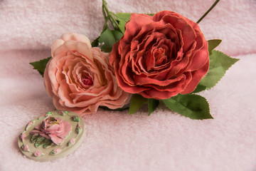 Two pink roses on the pinky soft fabric, isolated
