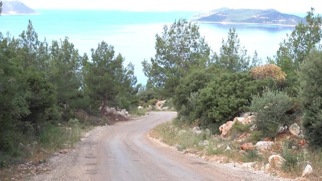 4K Zoom out whirling road downhill with stunning sea view