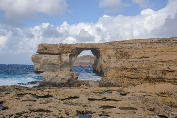 Azure window, natural hole of rocky cliff and blue Mediterranean sea. Famous travel destination of Malta on Gozo island