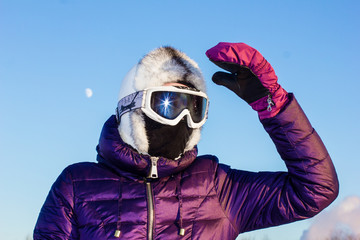 woman in ski mask goggles and ski overalls on a frosty snow day