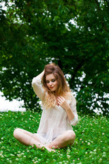 Obraz premium Young blonde woman on green meadow