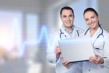 Male doctors with stethoscope using computer on background